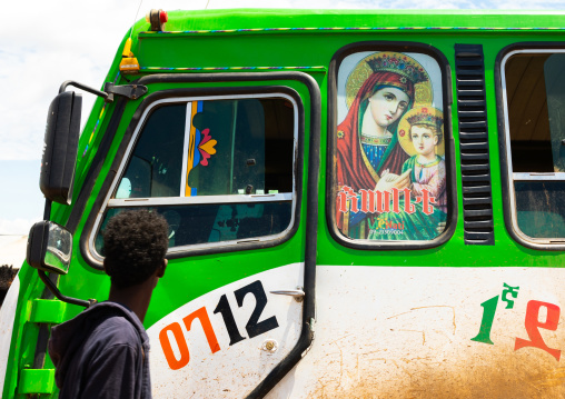 Bus decorated with virgin mary christian icon bringing muslim pilgrims, Oromia, Sheik Hussein, Ethiopia