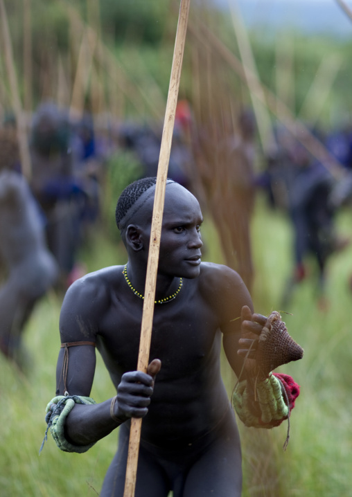Suri tribe warriors fighting during a donga stick ritual, Omo valley, Tulgit, Ethiopia