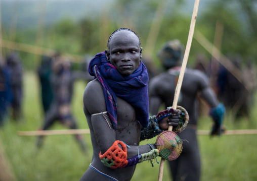 Suri tribe warriors fighting during a donga stick ritual, Omo valley, Tulgit, Ethiopia