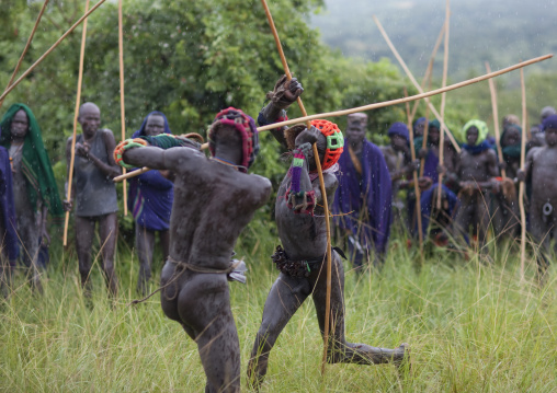 Suri tribe warriors fighting during a donga stick ritual, Omo valley, Tulgit, Ethiopia
