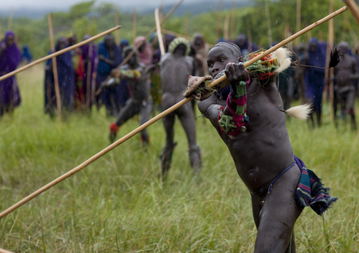Suri tribe warriors fighting during a donga stick ritual, Omo valley, Tulgit, Ethiopia