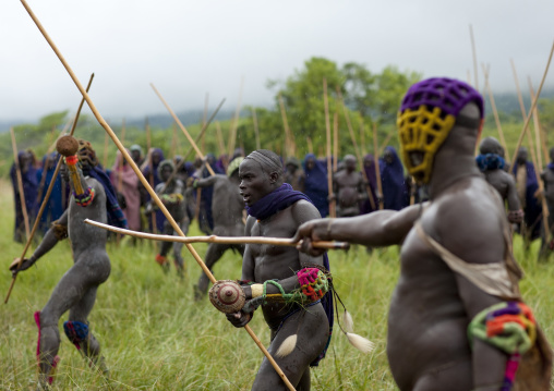 Suri tribe warriors fighting during a donga stick ritual, Omo valley, Tulgit, Ethiopia