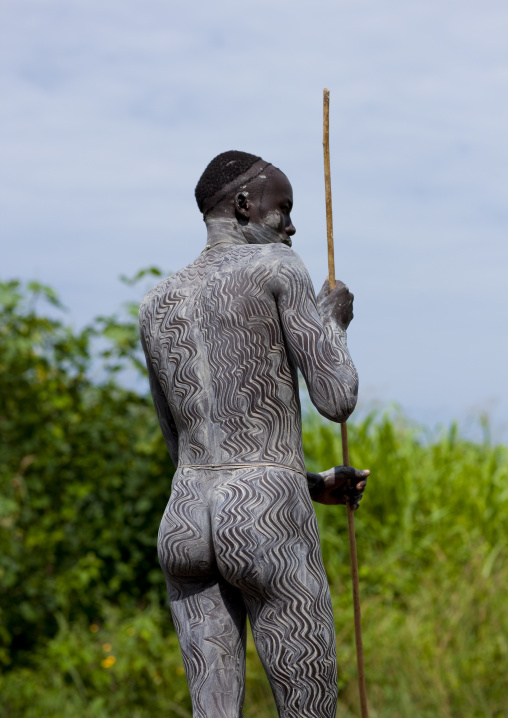 Surma warrior with clay body paintings, Turgit village, Omo valley, Ethiopia