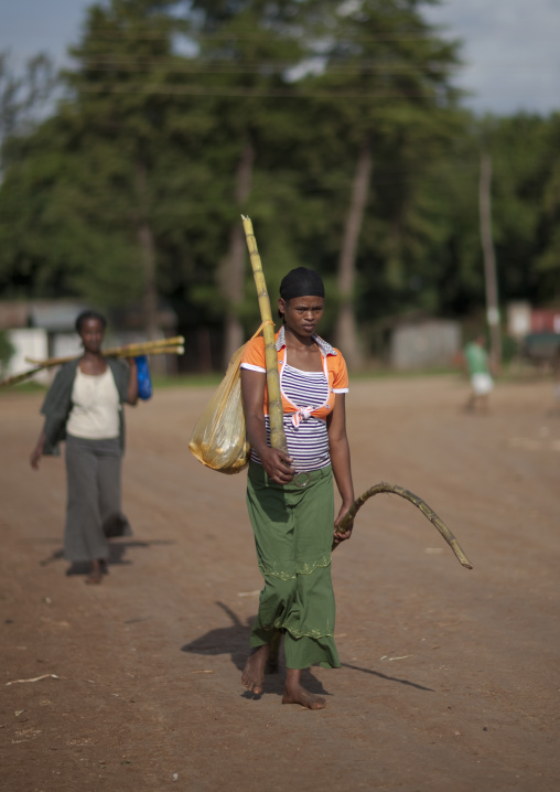 Woman Carrying Bottles From Salvage In A Plastic Bag, Village Of Tepi, Ethiopia