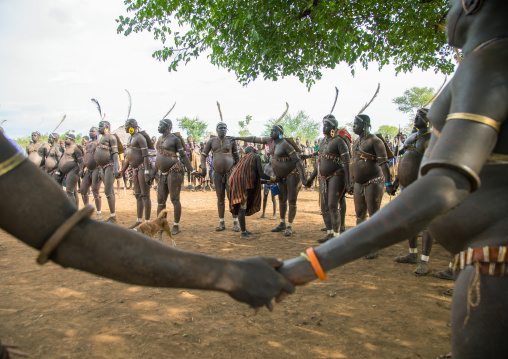 Bodi tribe fat men holding hands during Kael ceremony, Omo valley, Hana Mursi, Ethiopia