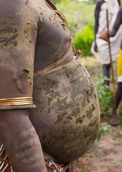 Bodi tribe fat man with cow dungs on his belly during Kael ceremony, Omo valley, Hana Mursi, Ethiopia