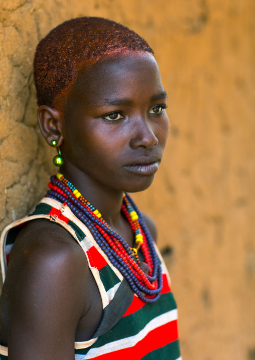 Portrait of a young woman from Hamer tribe with short hair, Omo valley, Turmi, Ethiopia