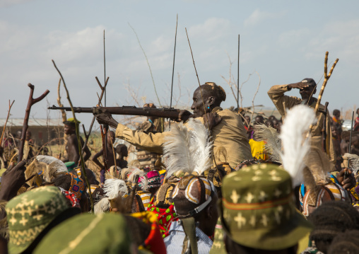Man shooting with a kalashnikov during the proud ox ceremony in the Dassanech tribe, Turkana County, Omorate, Ethiopia