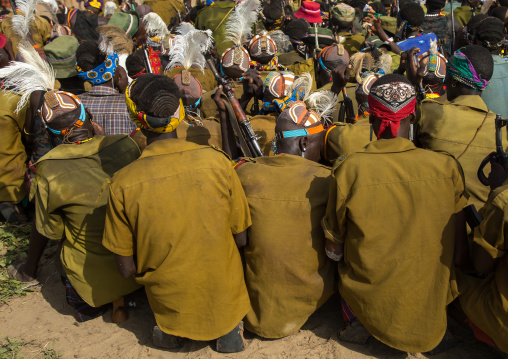 Tribe warriors during the proud ox ceremony in the Dassanech tribe waiting to share the cow meat, Turkana County, Omorate, Ethiopia