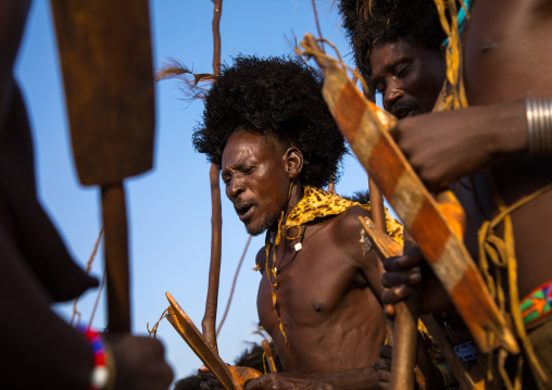 Dassanech men with leopard skins and ostrich feathers wigs during Dimi ceremony to celebrate circumcision of teenagers, Turkana County, Omorate, Ethiopia