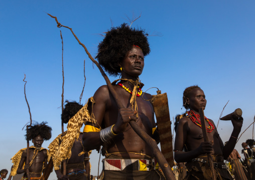 Dassanech men with leopard skins and ostrich feathers wigs during Dimi ceremony to celebrate circumcision of teenagers, Turkana County, Omorate, Ethiopia