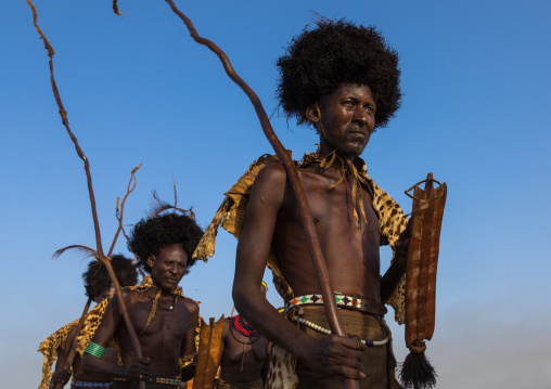 Dassanech men with leopard skins and ostrich feathers wigs during Dimi ceremony to celebrate circumcision of teenagers, Turkana County, Omorate, Ethiopia