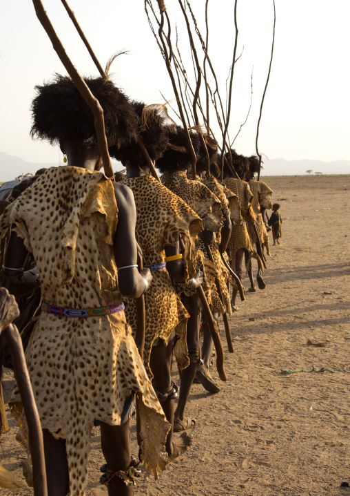 Dassanech men with leopard skins and ostrich feathers wigs during Dimi ceremony to celebrate circumcision of teenagers, Turkana County, Omorate, Kenya