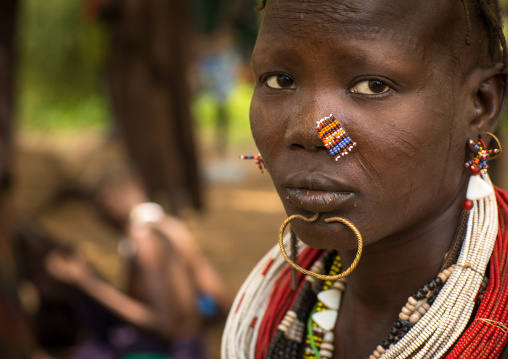Portrait of a sudanese Toposa tribe woman refugee with nose decoration and scarifications, Omo Valley, Kangate, Ethiopia