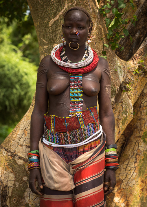 Portrait of a sudanese Toposa tribe woman refugee with huge necklaces and nose decoration, Omo Valley, Kangate, Ethiopia