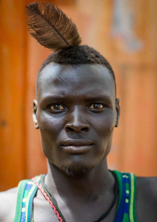 Sudanese Toposa tribe man refugee with a feather in his hair, Omo Valley, Kangate, Ethiopia
