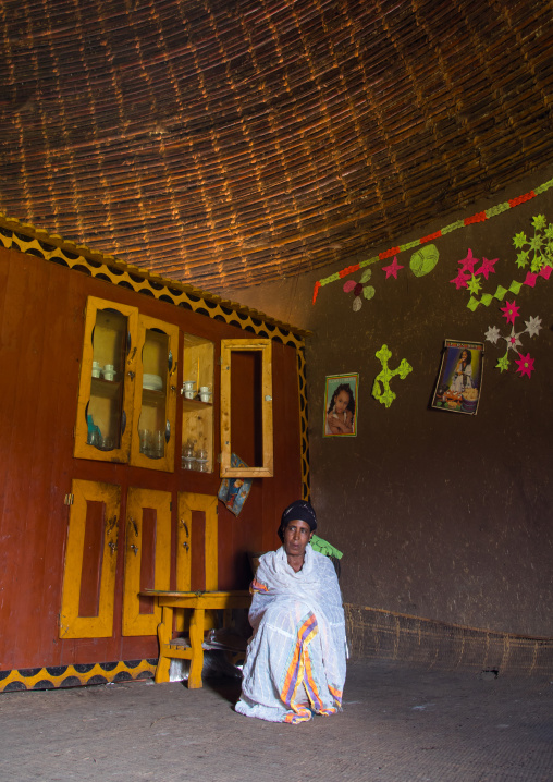 Gurage woman inside her traditional house decorated with doilies on the walls, Gurage Zone, Butajira, Ethiopia