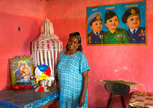 Ethiopian woman in her house decorated with a chinese poster, Omo valley, Jinka, Ethiopia