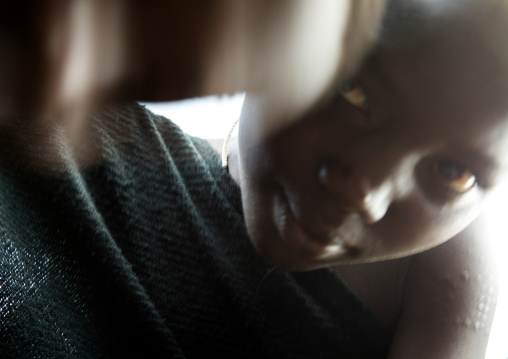 Young girl looking at the camera in the Bodi tribe, Omo valley, Hana Mursi, Ethiopia