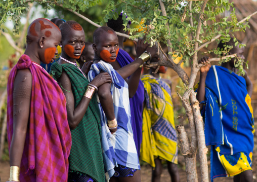 Teenage girls with makeup on the face during the fat men ceremony in Bodi tribe, Omo valley, Hana Mursi, Ethiopia