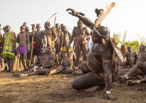 Bodi tribe fat man sitting during Kael ceremony, Omo valley, Hana Mursi, Ethiopia