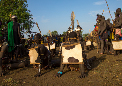 Bodi tribe fat men resting during Kael ceremony, Omo valley, Hana Mursi, Ethiopia