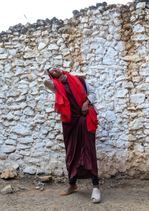 Sufi woman with a red veil into trance during a muslim ceremony, Harari Region, Harar, Ethiopia
