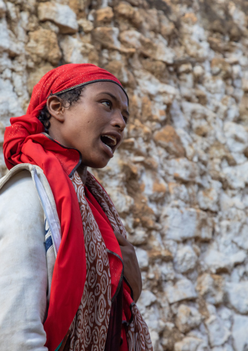 Sufi woman with a red veil into trance during a muslim ceremony, Harari Region, Harar, Ethiopia