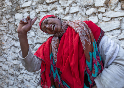 Sufi woman with a red veil into trance during a muslim ceremony, Harari Region, Harar, Ethiopia
