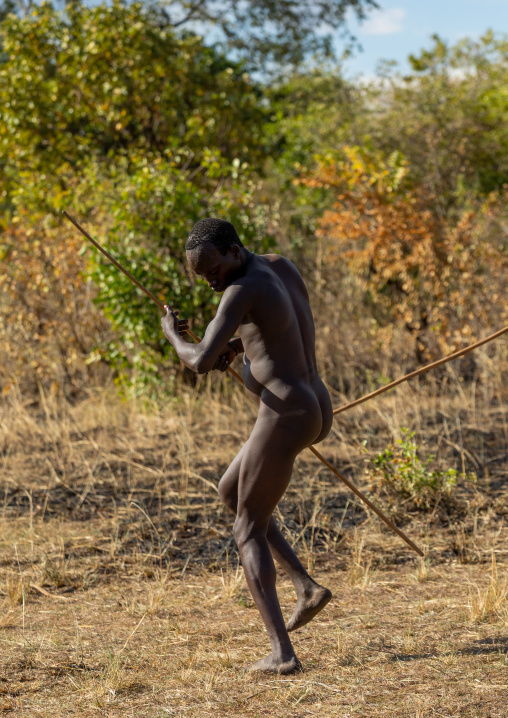 Suri tribe warrior dancing during a donga stick fighting ritual, Omo valley, Kibish, Ethiopia