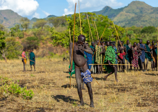 Suri tribe warrior dancing during a donga stick fighting ritual, Omo valley, Kibish, Ethiopia