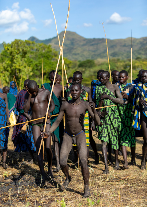 Suri tribe warriors parading before a donga stick fighting ritual, Omo valley, Kibish, Ethiopia