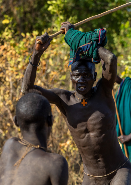 Suri tribe warriors fighting during a donga stick ritual, Omo valley, Kibish, Ethiopia