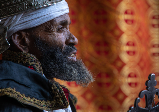 Ethiopian orthodox priest in nakuto lab rock church holding a cross, Amhara Region, Lalibela, Ethiopia