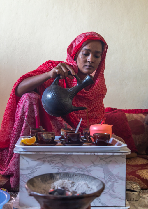 Ethiopian woman serving traditional coffee, Afar Region, Assayta, Ethiopia