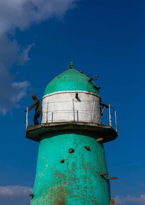 Man on the balcony of the  dengogo mosque green minaret, Harari Region, Dengogo, Ethiopia