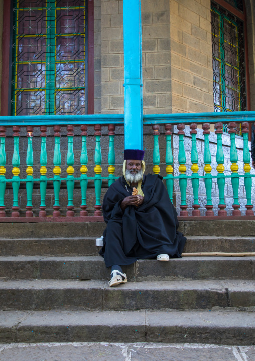 Priest sit on the stairs of the Entoto orthodox Maryam Church, Addis Ababa Region, Addis Ababa, Ethiopia