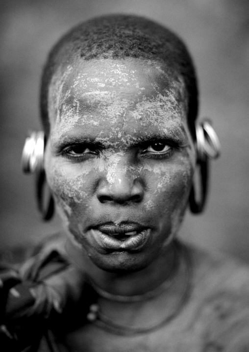 Suri tribe woman with an enlarged earlobe and painted face, Kibish, Omo valley, Ethiopia