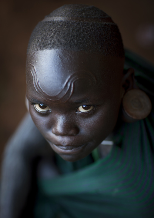 Suri tribe girl with facial scarifications, Kibish, Omo valley, Ethiopia