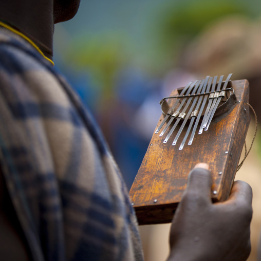 Detail of a Suri tribe person holding a kalimba, Kibish, Omo valley, Ethiopia