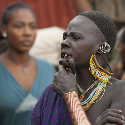Suri tribe woman with enlarged earlobe and scarifications, Kibish, Omo valley, Ethiopia