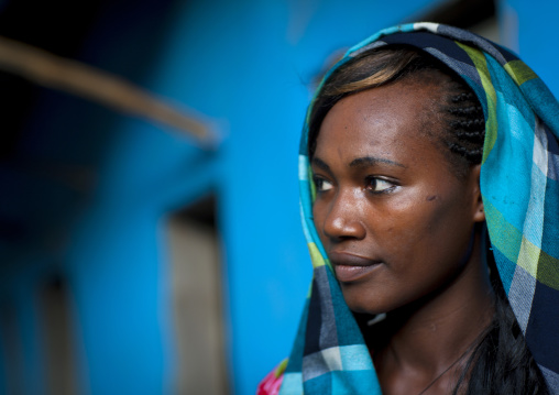 Young waitress with a veil in hana mursi hotel, Omo valley, Ethiopia
