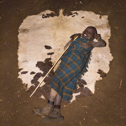 Bodi Tribe Kid Lying On A Cow Skin, Hana Mursi, Omo Valley, Ethiopia