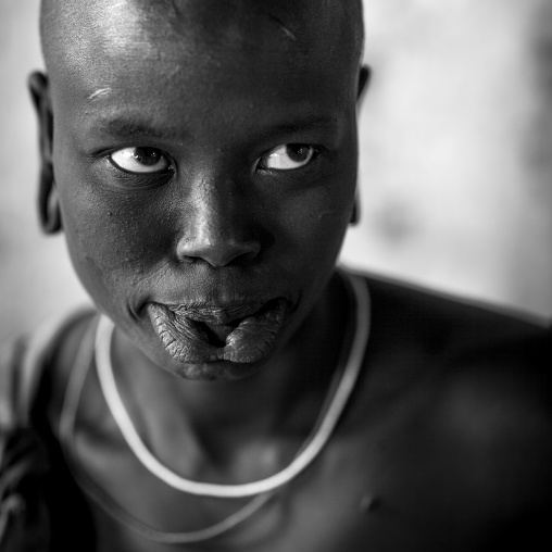 Portrait Of A Young Mursi Tribe Woman With Enlarged Lip In Mago National Park, Omo Valley, Ethiopia