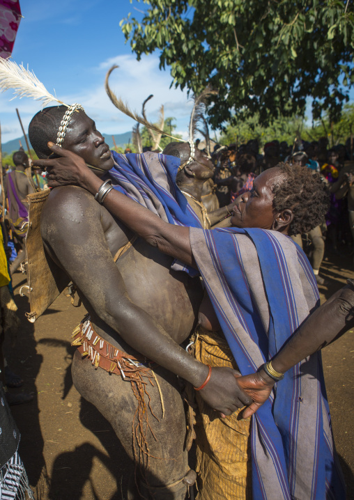 Bodi Tribe Woman Putting Water On The Face Of A Fat Man During Kael Ceremony, Hana Mursi, Omo Valley, Ethiopia