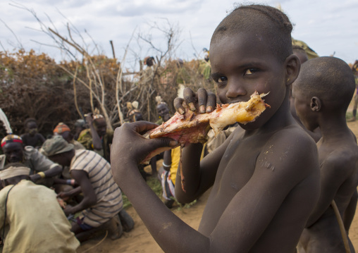 Dassanech Tribe Warriors Sharing Cow Meat During A Ceremony, Omorate, Omo Valley, Ethiopia