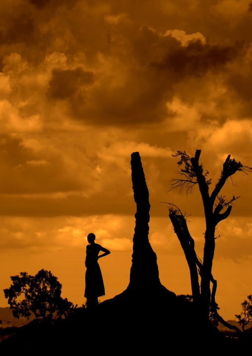 Silhouette Of A Woman Standing On A Termite Mount At Sunset, Borana Tribe Area, Omo Valley, Ethiopia