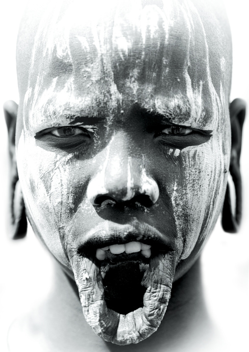 Portrait Of A Black And White Portrait Of A Mursi Tribe Woman With Enlarged Lip And Ears In Mago National Park, Omo Valley, Ethiopia