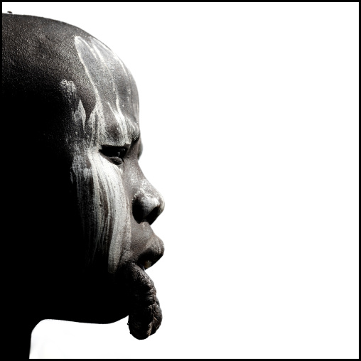 Profile Of A Mursi Tribe Woman With White Paint On Her Face And An Inferior Dilated Lip Hanging, Omo Valley, Ethiopia