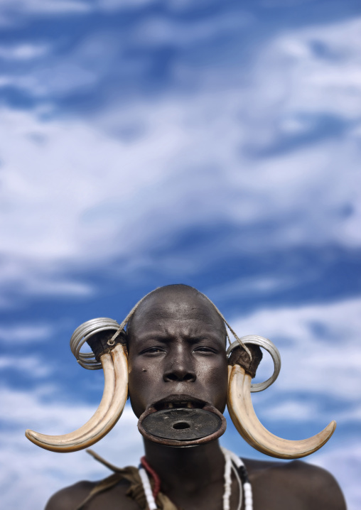 Portrait Of A Mursi Tribe Woman With Lip Plate And Enlarged Ears In Mago National Park, Omo Valley, Ethiopia